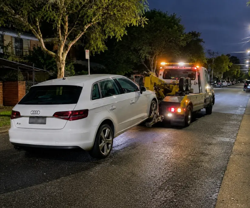 Audi A3 being towed at night